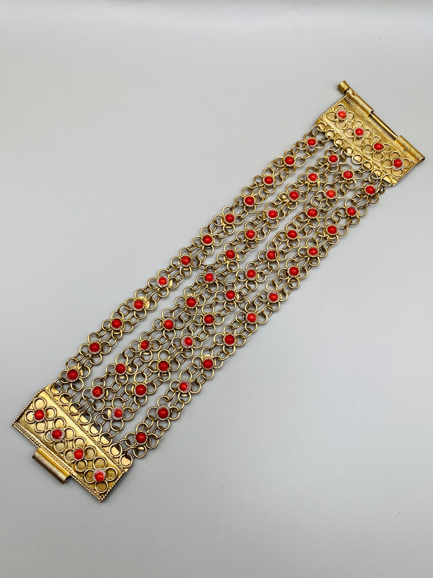 Bracelet vintage 70s – Manchette ajourée dorée & cabochons corail
